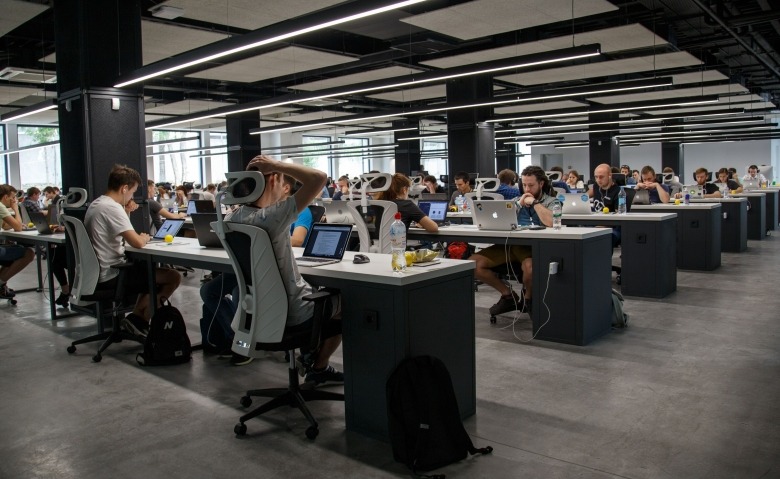 Employees working on computers in casual open floor plan setting