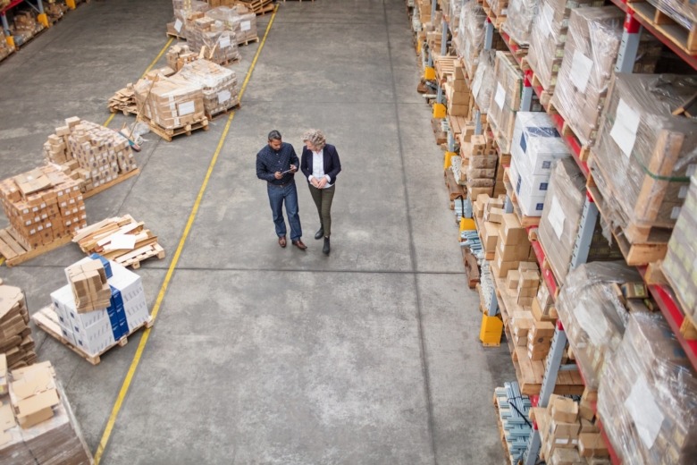 two men walking through warehouse