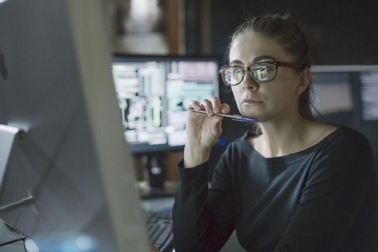 Woman wearing eyeglasses making data-driven decision on computer