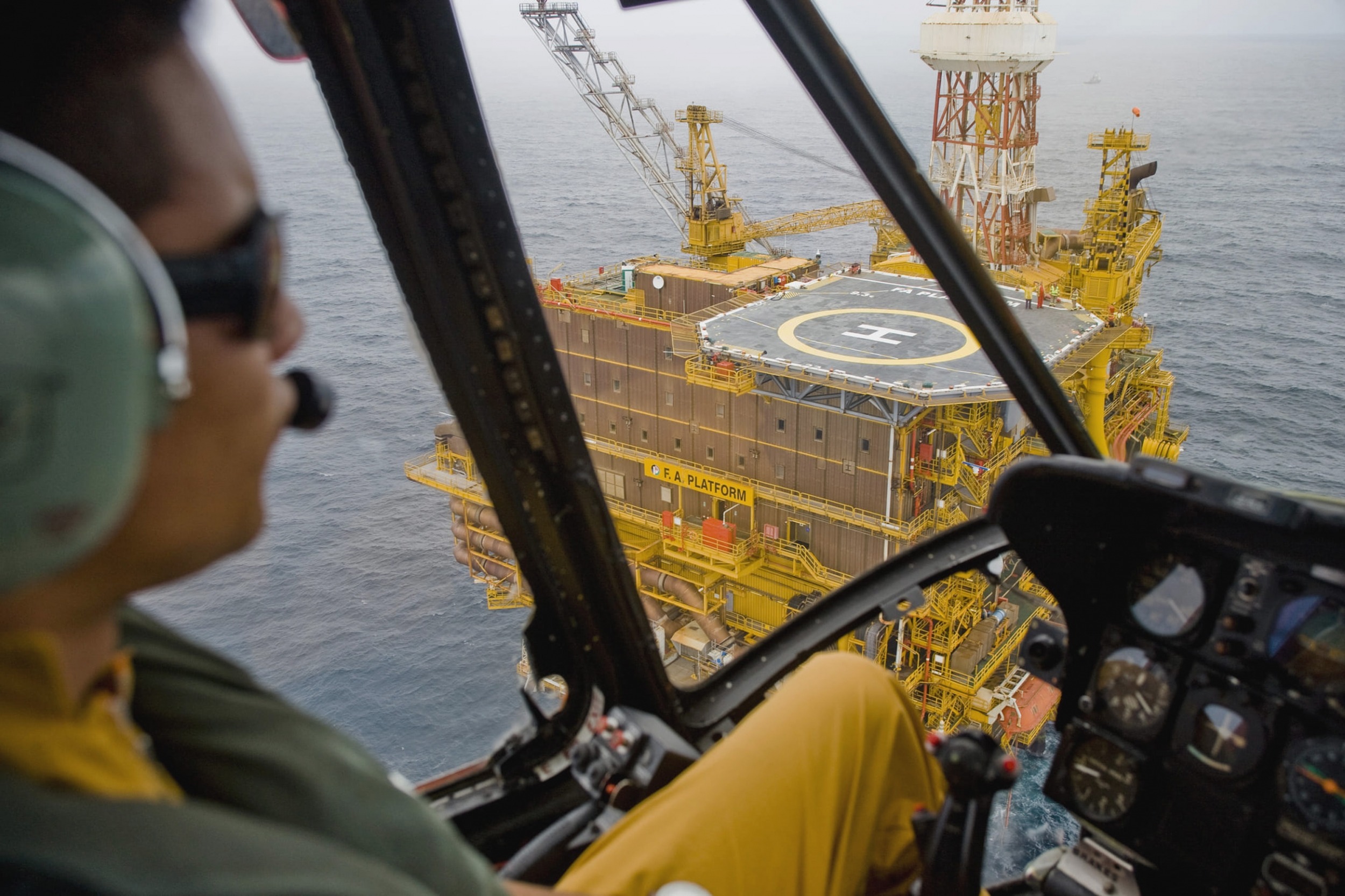 Risk Register Software helicopter pilot approaching drilling rig