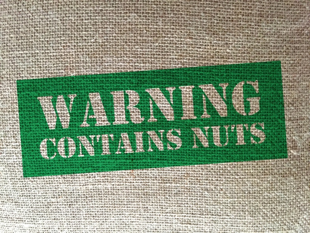Burlap bag stamped 'Warning, contains nuts
