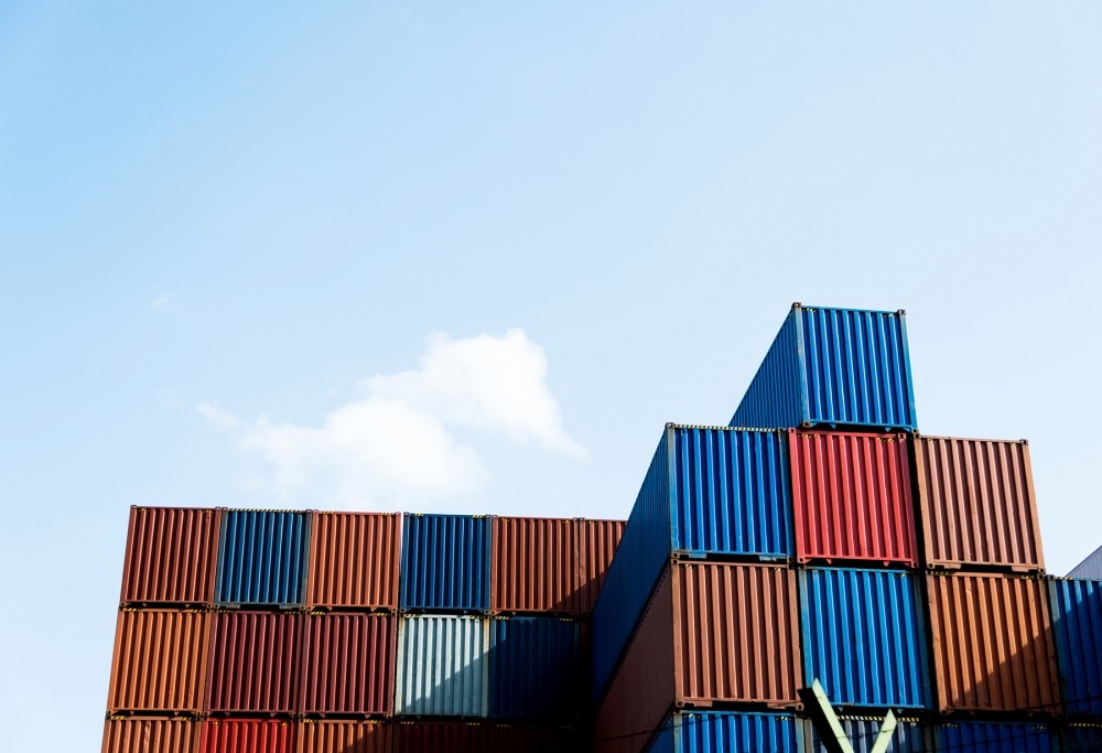 supplier integration Stacks of cargo containers under blue sky