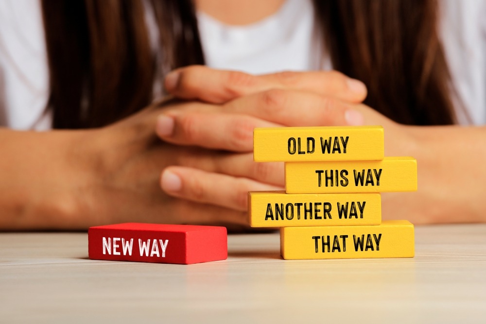 Change management. Red block on left that says 'old way' and 4 blocks on right that say 'this way,' 'that way,' 'another way' and 'new way.'