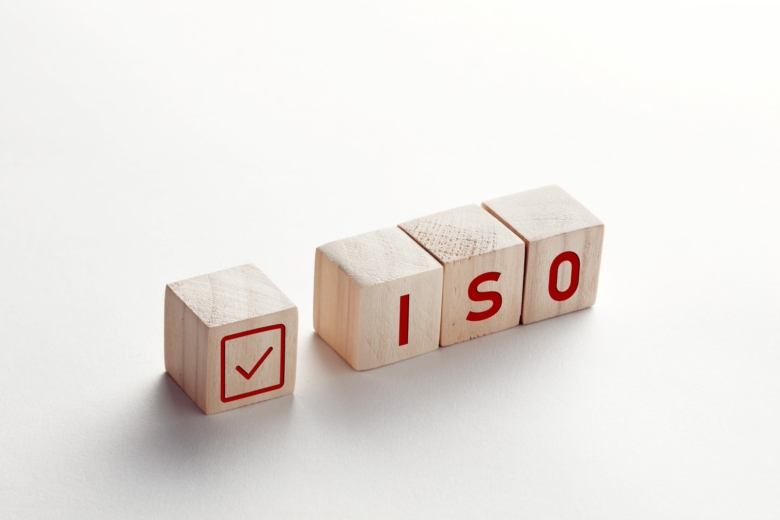 blocks spelling out iso with a checkmark