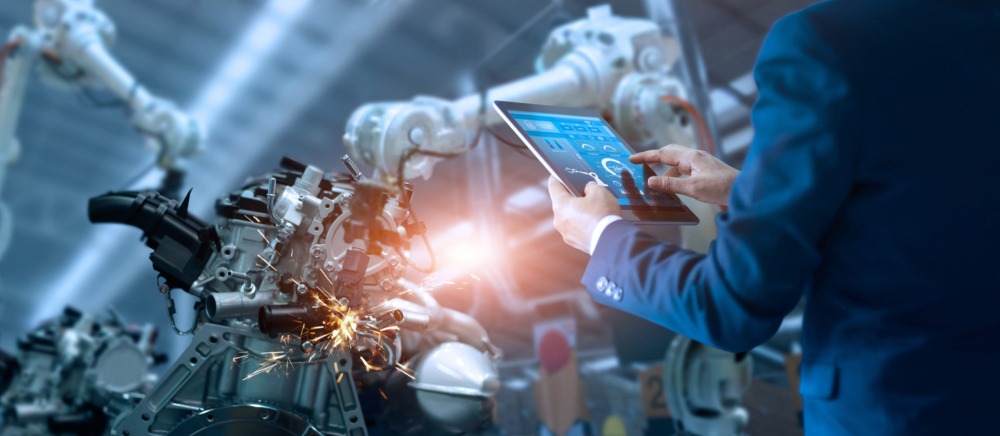 Engineer using robot to weld product digital transformation